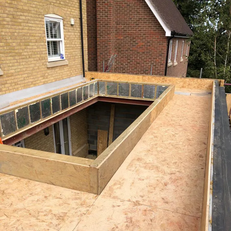 a house being built with a flat roof