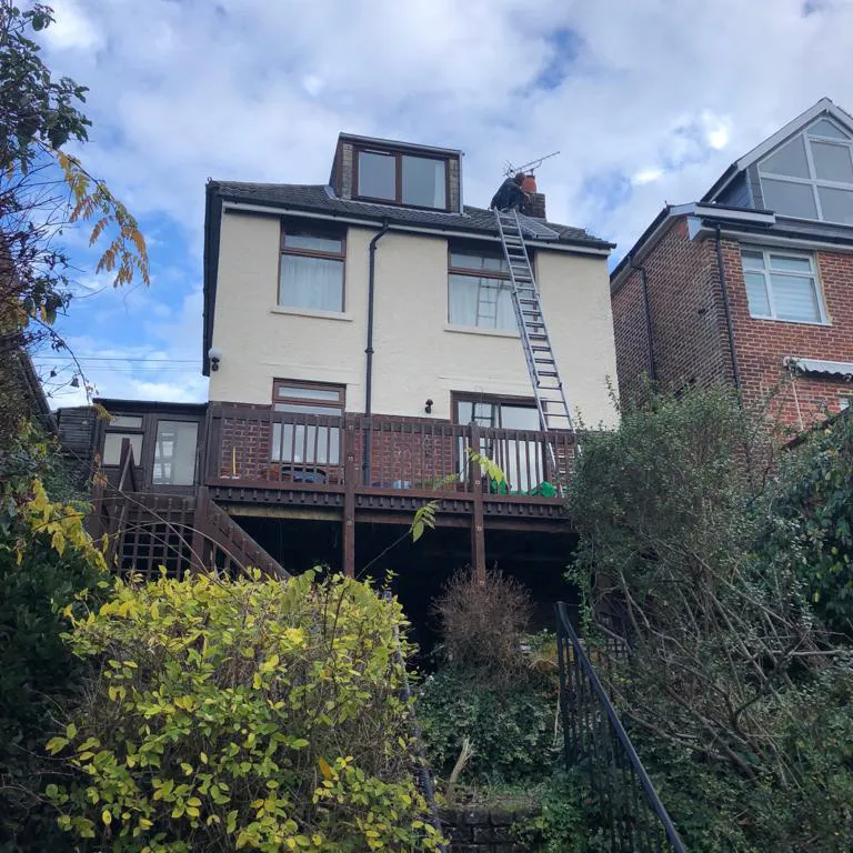 a house with a ladder going up the side of it